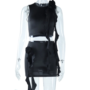 Close-up of 3D handmade floral details and ruffle trim on black bodycon skirt set