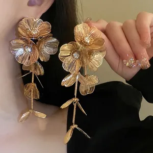 Statement golden flower tassel drop earrings with intricate hollow metal mesh petals