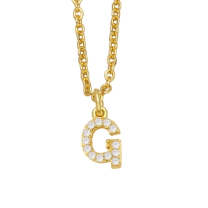 Detailed macro view of gold-plated G-letter pendant necklace with sparkling pavé crystals