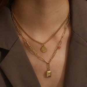 Double-layered gold titanium necklace with starburst coin and rectangle diamond pendants