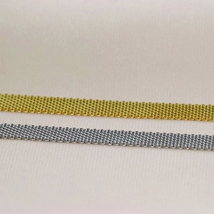 Macro view of 8mm gold and silver hollow metal mesh weave necklace texture and detail