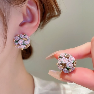 Detail view of purple ceramic flower cluster earrings with sparkling rhinestones