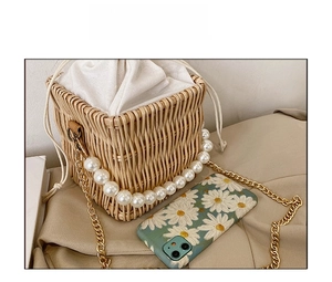 Detailed comparison of mini straw bag with pearl handle and golden chain strap