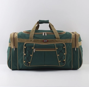 Close-up of a large waterproof travel bag in green and khaki with front zipper pockets