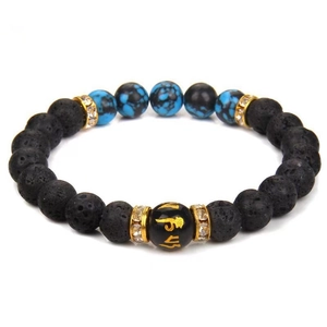 Close-up of lava rock yoga bracelet featuring six-syllable mantra bead and gold spacers