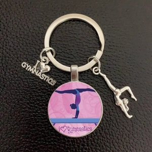 Creative I Love Gymnastics keychain with silver charms and pink glass pendant on leather