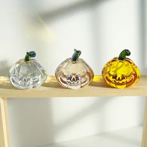 Three-piece set of Halloween crystal pumpkins with Jack-O-Lantern faces on a wooden stand