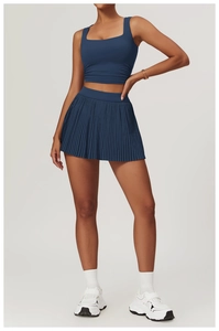 Detail of navy blue cropped square neck tank top and high waisted pleated tennis skirt set