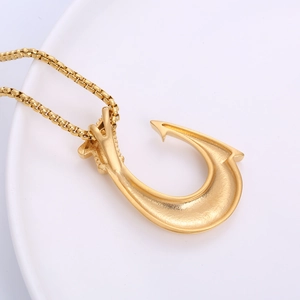 18k gold plated stainless steel Viking fish hook pendant necklace on white ceramic tray