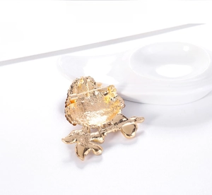 Detailed back view showing the gold-plated alloy structure and secure safety pin clasp