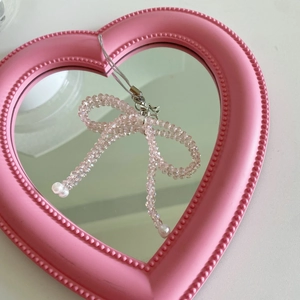 Pink crystal beaded bow phone charm on a heart mirror with faux pearl details