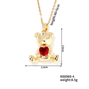 Detail of golden bear pendant with red heart zircon and precise size measurements