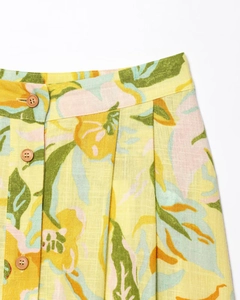 Detailed view of linen blend floral skirt waist featuring three brown wooden buttons