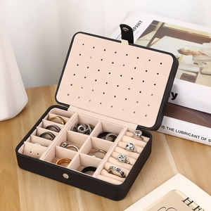 Portable double-layer black leather jewelry box with beige velvet lining and compartments