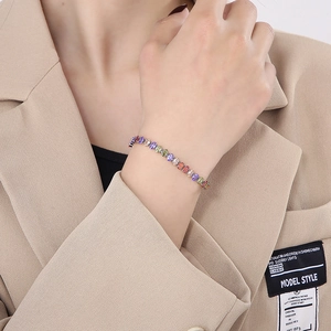 Colorful zircon tennis bracelet in titanium steel worn with a beige textured blazer