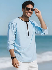 Detail view of light blue linen Henley shirt featuring wood buttons and contrast neckline