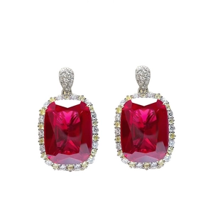 Detailed view of luxury ruby red gemstone earrings with sparkling crystal accents