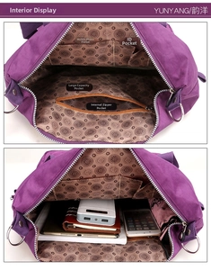 Detailed view of the purple nylon tote internal storage compartments and main zip pocket