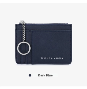 Detail view of navy blue cross-grain leather card holder with card slots and key chain