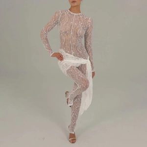 Detail of white lace jumpsuit featuring transparent mesh sleeves and elegant waist tie design