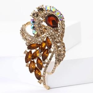 Detail of vintage gold alloy brooch with large amber crystals and sparkling rhinestones