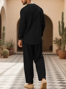 Rear view of black long-sleeve cotton linen casual suit for men in an outdoor courtyard