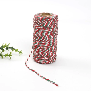 Macro view of 2mm red green and white cotton twine roll for Christmas gift wrapping decor