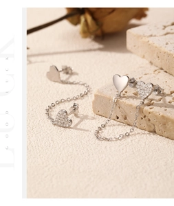 Macro detail of s925 silver heart tassel earrings with sparkling pavé cubic zirconia