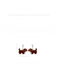 Detail view of flocked dog pendant earrings with copper base and zircon accents