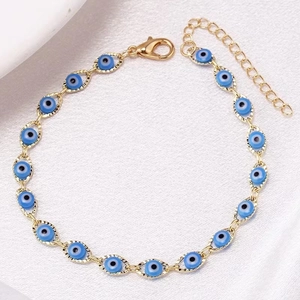 Close-up of golden metal chain bracelet with multiple blue evil eye marquise charms