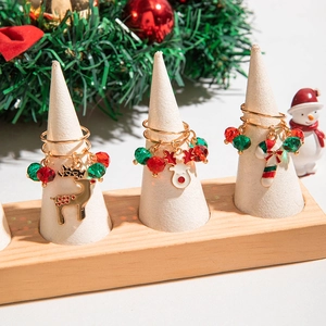 Detailed view of Christmas themed ring set with elk and candy cane on display stands