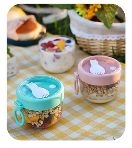 Close-up of portable yogurt cups with colorful lids and built-in spoons for breakfast