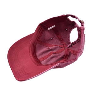 Detail view of burgundy ponytail baseball cap showing rear opening and inner cotton lining