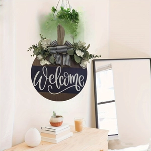 Welcome wooden door sign with burlap bow and greenery shown in a home interior setting