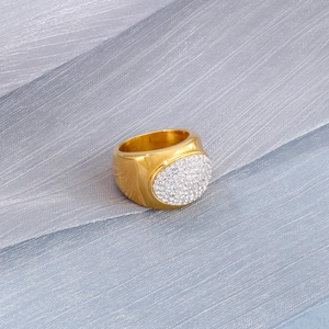 Close-up of gold plated stainless steel signet ring with micro-paved white crystals
