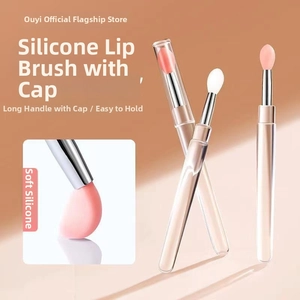 Detail of round silicone lip brush with cap showing soft bristles and long handle