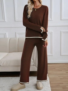 Detail of brown knit lounge set featuring contrast white piping on cuffs and hemline