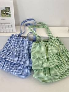 Plaid canvas tote bags with ruffle edges and drawstring in blue and green colors