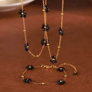 Parure collier et bracelet en acier titane plaqué or 18k avec breloques de fleurs marguerites