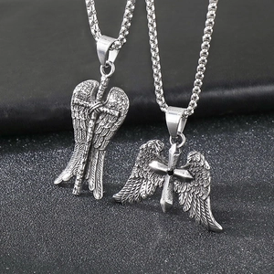 Close-up of vintage silver cross pendant with angel wings in polished stainless steel