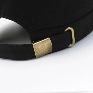 Rear view of minimalist black cotton military cap with adjustable bronze metal buckle strap