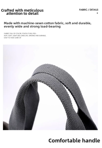 Close-up of reinforced canvas handles with precision white stitching on large tote bag