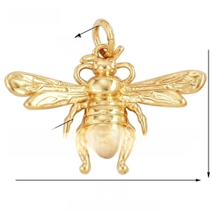 Macro detail of gold bee pendant jewelry showing 25mm wingspan and zircon inlay