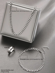 Detail showing silver stainless steel jewelry set with Cuban chain, bracelet, and ring