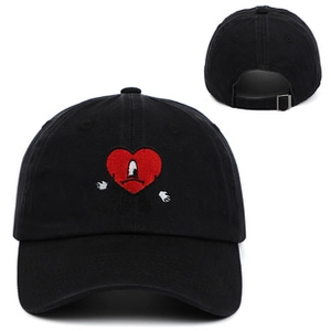 Detail of black washed cotton baseball cap with red heart embroidery and metal buckle