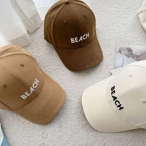 Three embroidered cotton baseball caps in brown, khaki and cream white for casual style