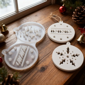 Macro shot of circular Christmas star stocking resin mold and finished HoHoHo ornaments