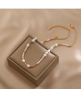 Detailed close-up of Baroque freshwater pearl necklace with gold metal beads and lobster clasp