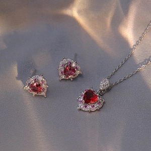 Elegant heart-shaped red zircon necklace and earrings set in polished silver finish