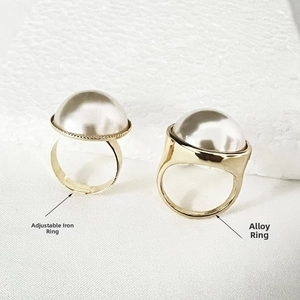 Detail of adjustable iron ring and alloy ring designs featuring large round white pearls